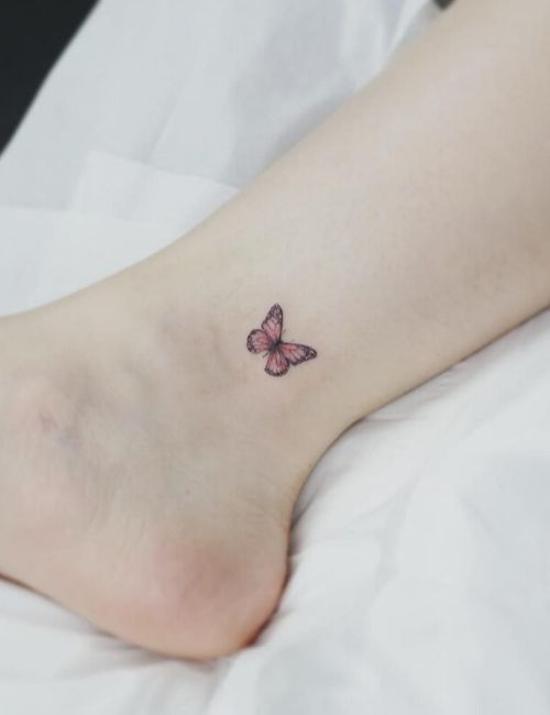 small butter fly tattoo on leg